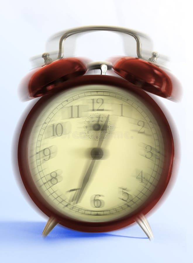 Ringing retro-styled alarm clock - close up on light blue background (movement blur). Ringing retro-styled alarm clock - close up on light blue background (movement blur).