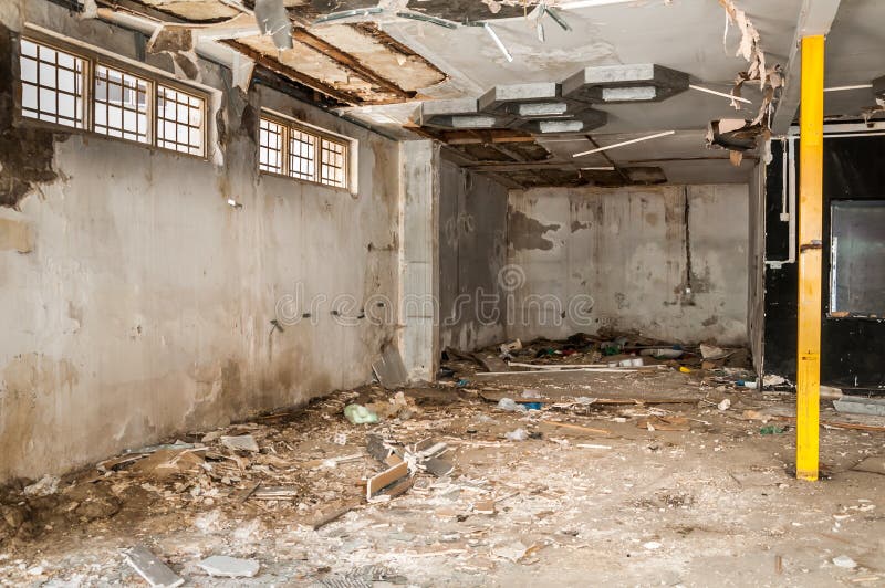 Remains of abandoned damaged and destroyed house interior by grenade shelling with collapsed roof and wall in the war zone selecti