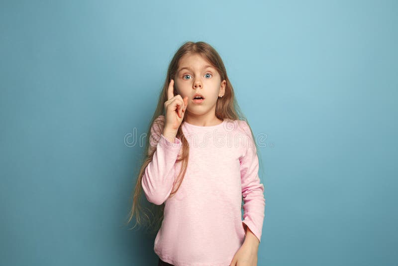 The remember all. Teen girl on a blue background. Facial expressions and people emotions concept royalty free stock images The remember all. Teen girl on a blue background. Facial expressions and people emotions concept royalty free stock images