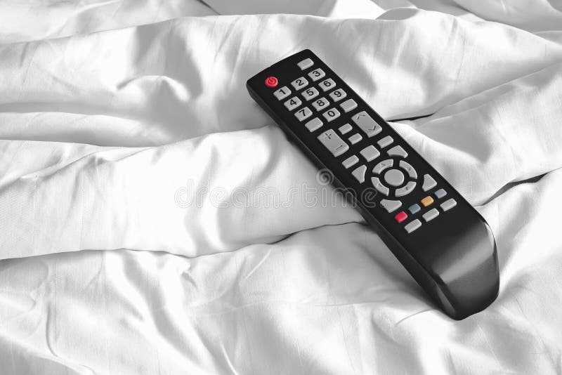 Remote on bed sheets stock photo. Image of watching, abstract 71617234