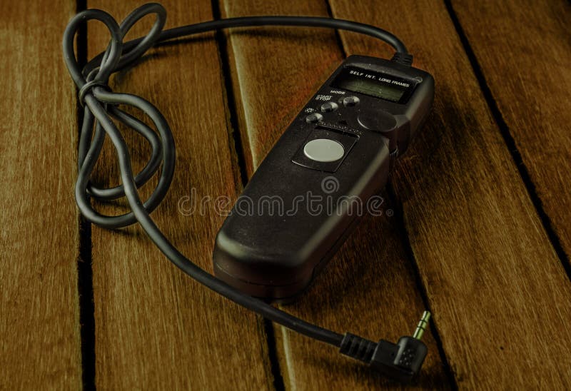 Remote camera shutter release on wooden table stock photography