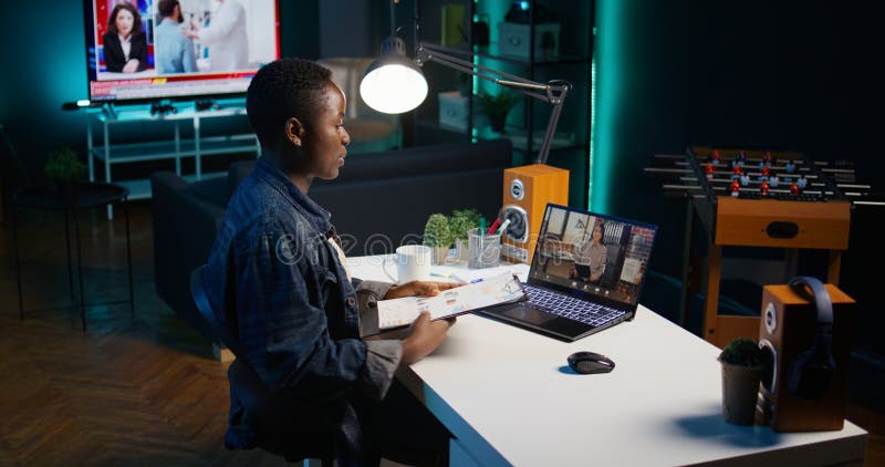 Remote employee talking in videoconference call with supervisor, showing graphs stock photography