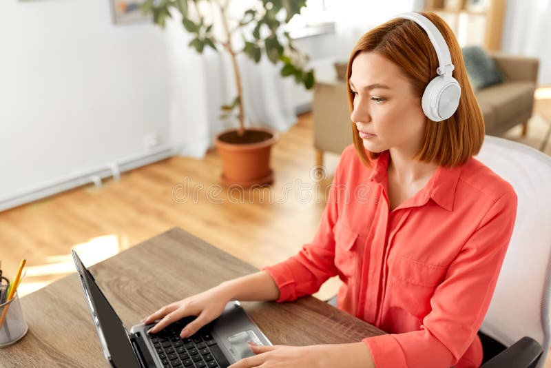Woman in headphones with laptop working at home royalty free stock photography Woman in headphones with laptop working at home royalty free stock photography