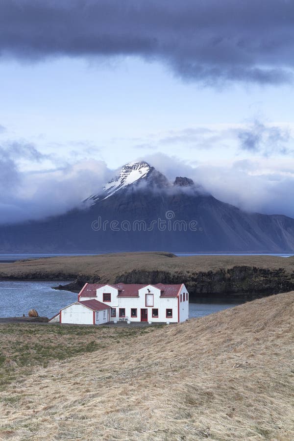 Remote white Icelandic house on the shores of Atlantic ocean
