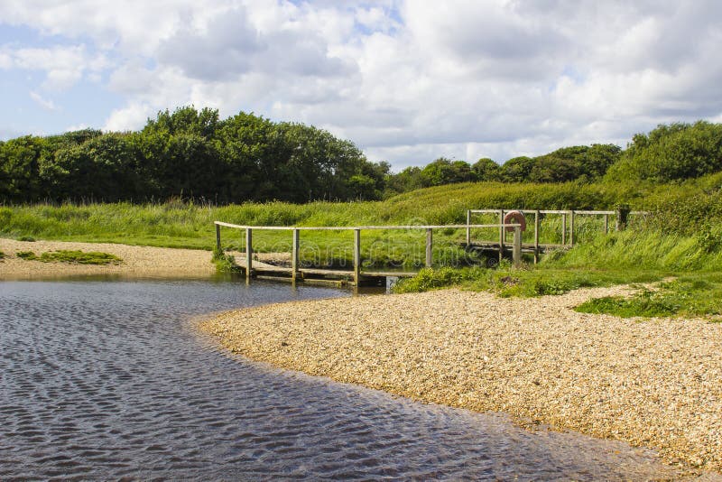 A remote wooden footbridge at the end of the Hook Lane bridle path near Titchfield Common England royalty free stock images