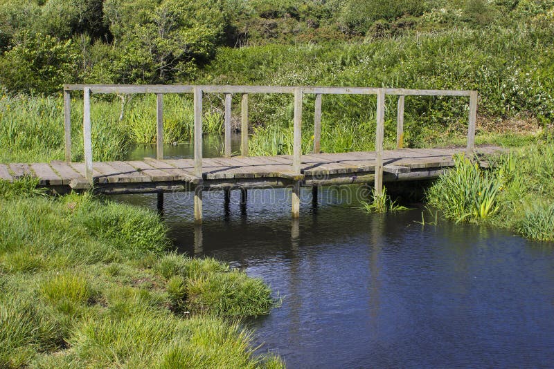A remote wooden footbridge at the end of the Hook Lane bridle path near Titchfield Common England royalty free stock photos