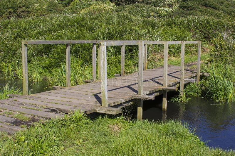 A remote wooden footbridge at the end of the Hook Lane bridle path near Titchfield Common England stock photos