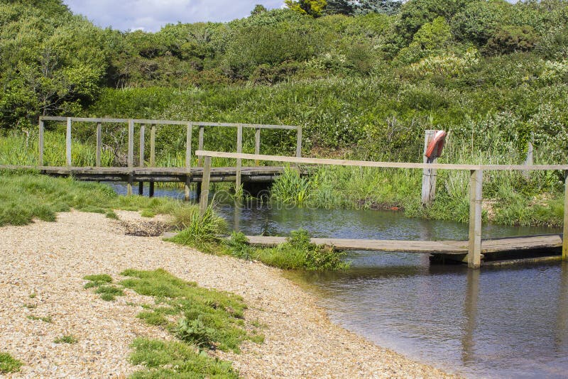A remote wooden footbridge at the end of the Hook Lane bridle path near Titchfield Common England stock image