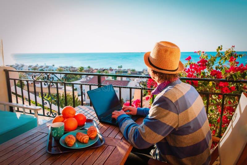 Remote work concept- young man with laptop on scenic terrace royalty free stock photo