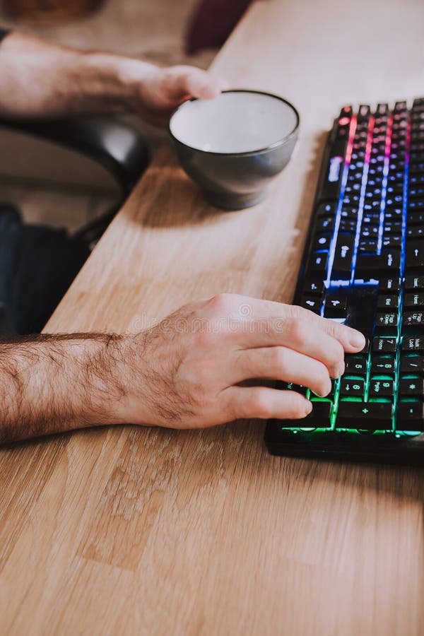 Remote Work Hands with a Cup of Tea and a Keyboard Stock Image