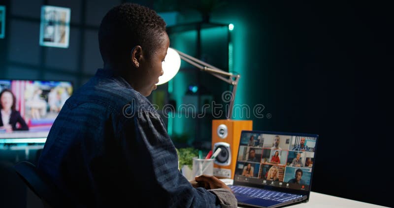 Remote worker greeting colleagues during business meeting on videocall stock photography