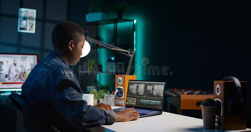 Remotely working videographer doing video montage using specialized software stock photo