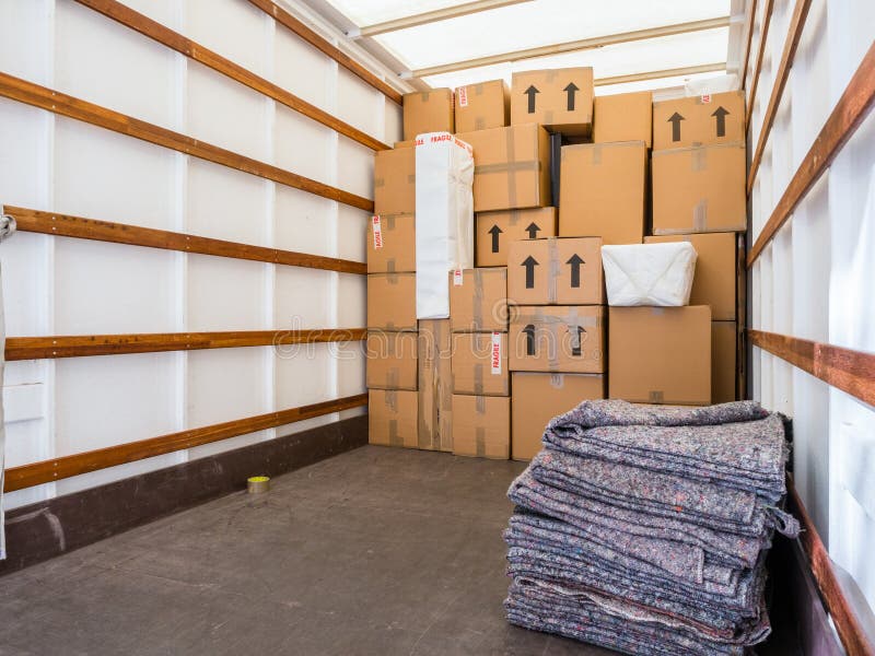 Removal Van Interior, Stacked Boxes and Blankets. Copy Space. Stock