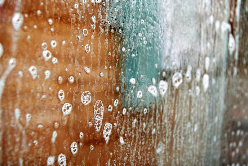 Removing limescale from the shower cabin with soap and chemistry royalty free stock photos