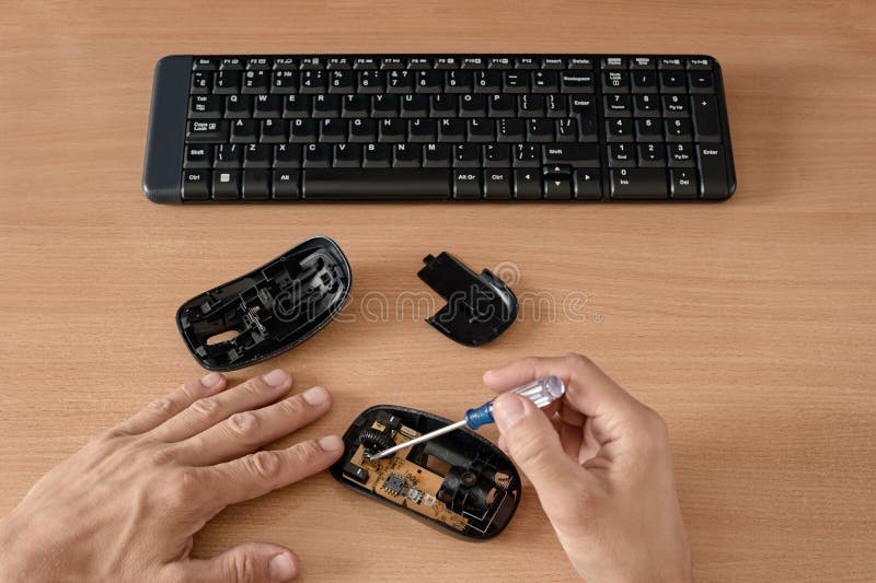 Rendering of computer mouse with repairing equipments on wooden table