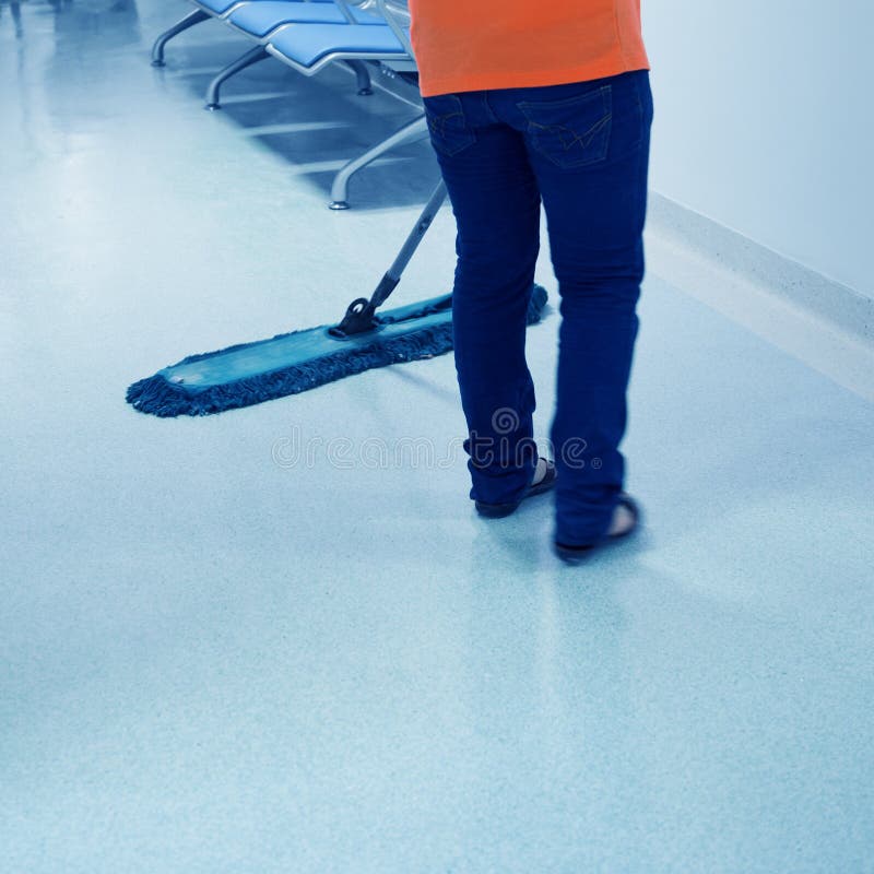 People cleaning floor in office building lobby. People cleaning floor in office building lobby