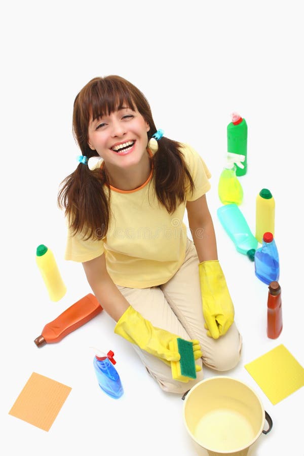 A happy house cleaning woman on a floor with sponge and household chemistry bottles,bucket isolated on a white background. A happy house cleaning woman on a floor with sponge and household chemistry bottles,bucket isolated on a white background