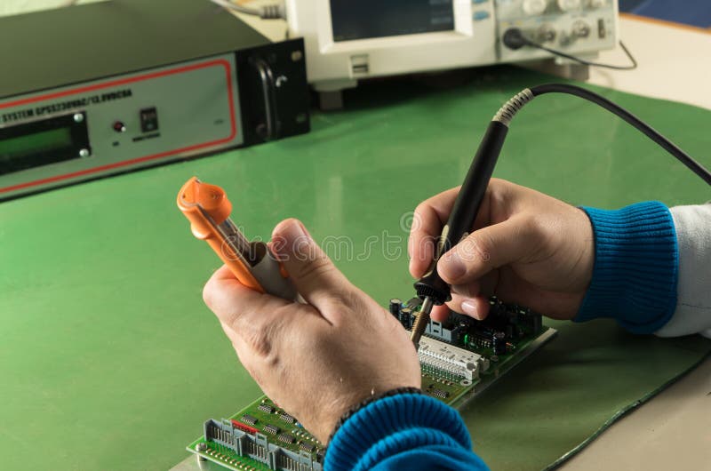 Repair Circuit Board with Soldering Iron and Pump in Laboratory Stock