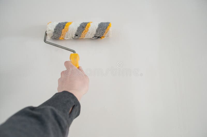 Repair concept, repair tools, priming the wall before laying the tiles on it, the final preparatory stage for strengthening the s. Urface royalty free stock images Repair concept, repair tools, priming the wall before laying the tiles on it, the final preparatory stage for strengthening the s. Urface royalty free stock images