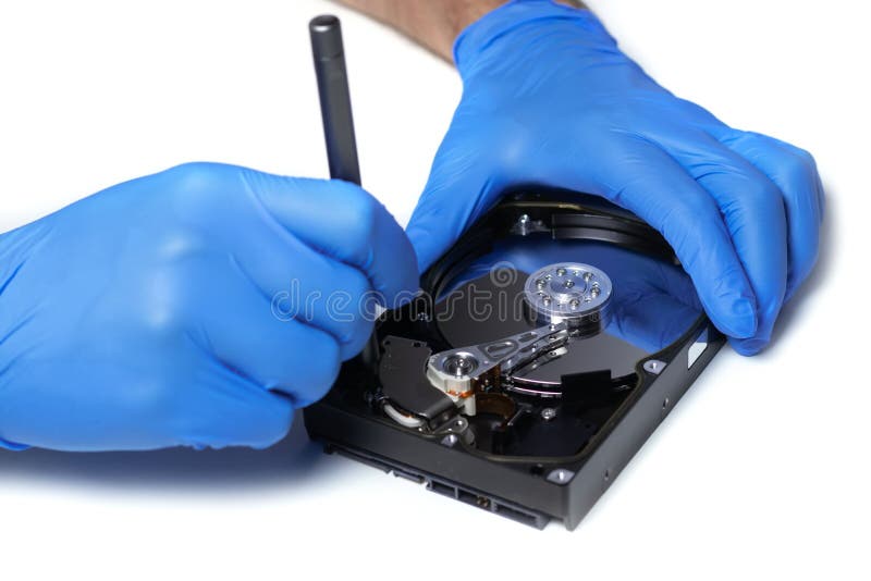 Repair Hard Disk. Hands of Master in Gloves with Screwdriver Repair the