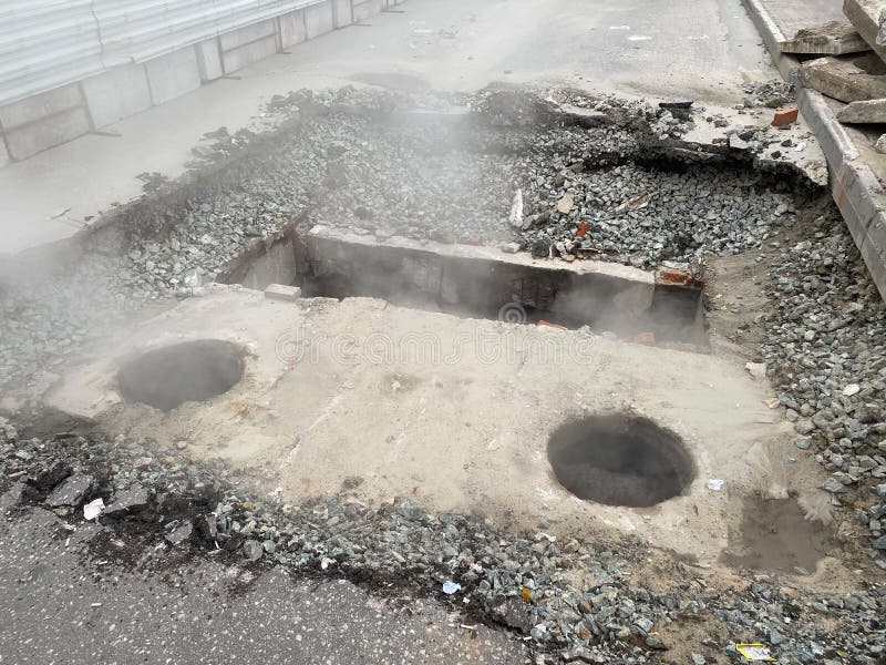 Repair of the heating main. The underground pipe through which steam flows is damaged royalty free stock image