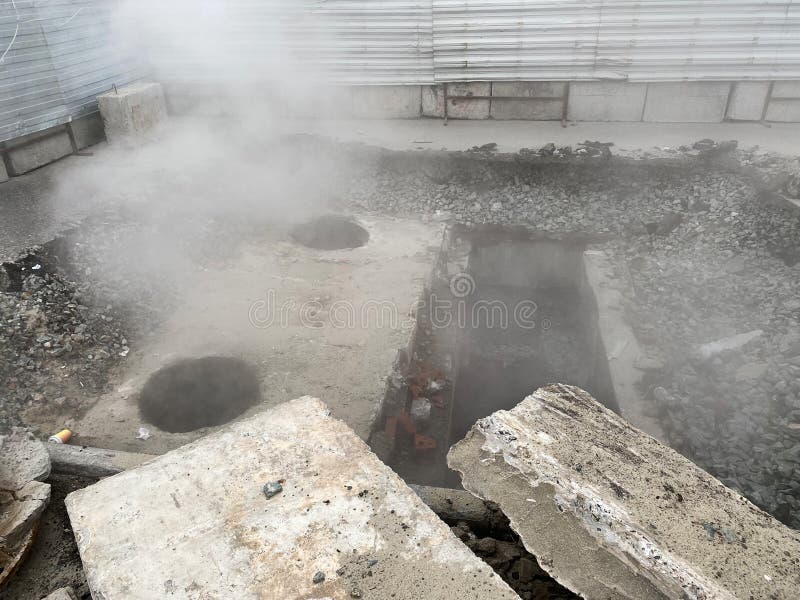 Repair of the heating main. The underground pipe through which steam flows is damaged stock image