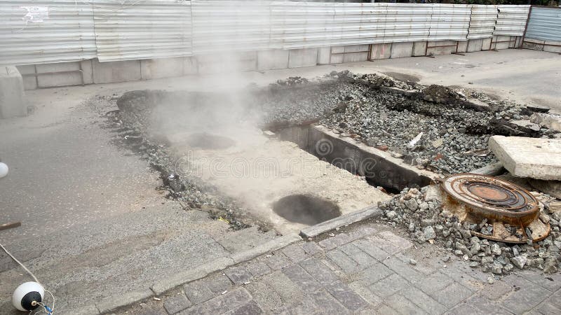 Repair of the heating main. The underground pipe through which steam flows is damaged royalty free stock photography