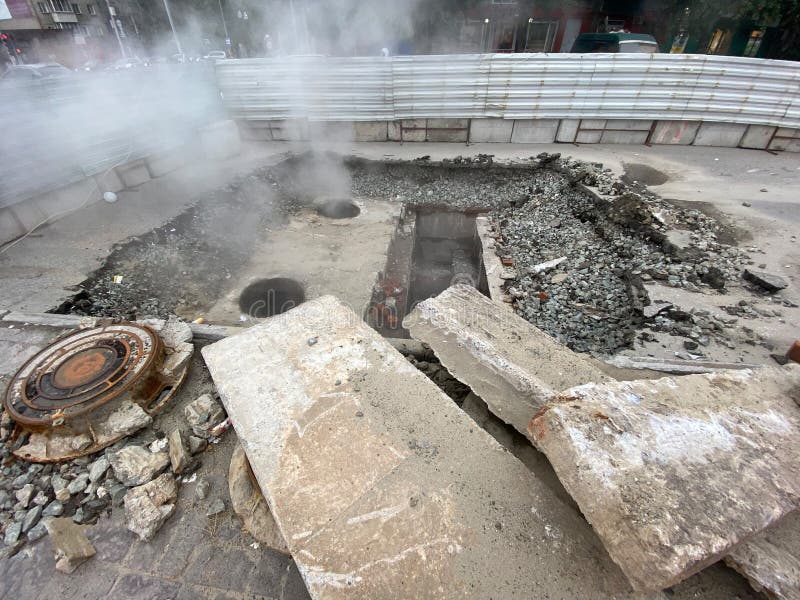 Repair of the heating main. The underground pipe through which steam flows is damaged royalty free stock photo