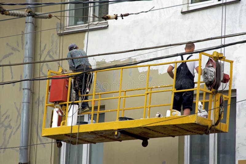 Repair and restoration of a facade of a building in the city royalty free stock photography Repair and restoration of a facade of a building in the city royalty free stock photography