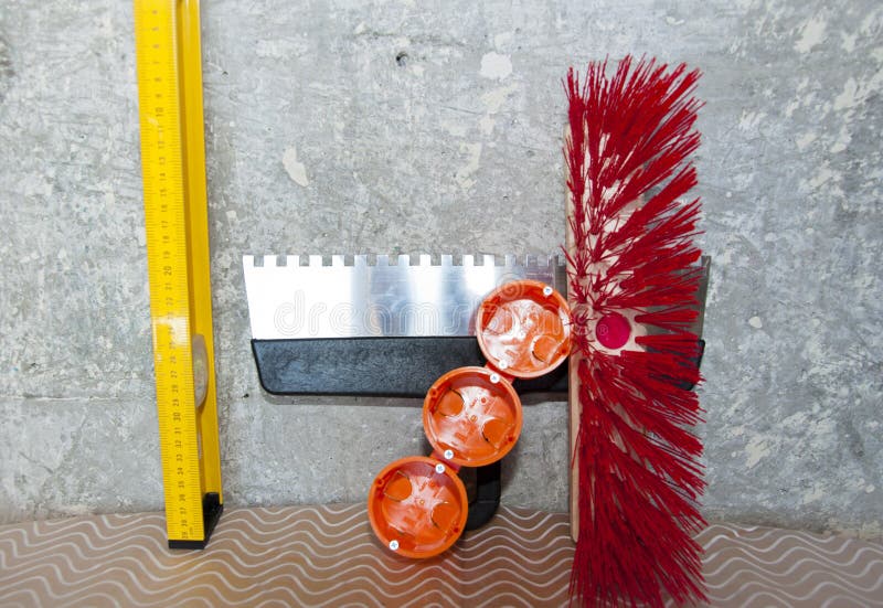 Repair tool set. putty knife, brush broom, bushings for sockets and building level. socket box with spatula and measuring balance level, fetlock on damaged wall background. repair and construction