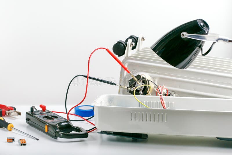 Repairing, Maintenance, Service an Electric Heater on Grey Surface