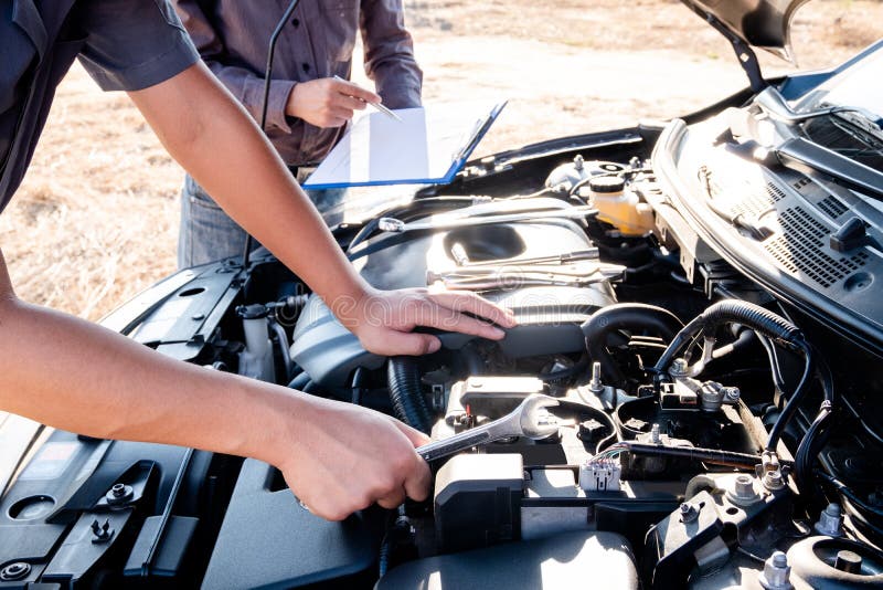 Repairman and Insurance Agent Checking Engine Order Using Modern Tools
