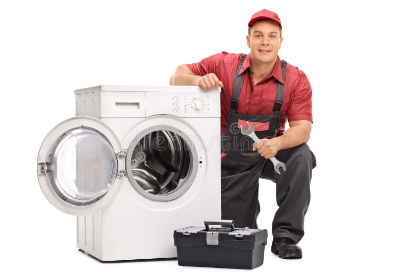Repairman naprawia pralkę zdjęcia stock