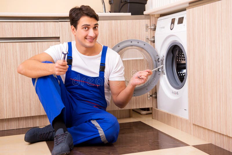 The Repairman Repairing Washing Machine at Kitchen Stock Image Image