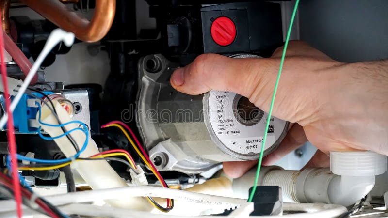 A repairman repairs home - type natural gas combi boiler