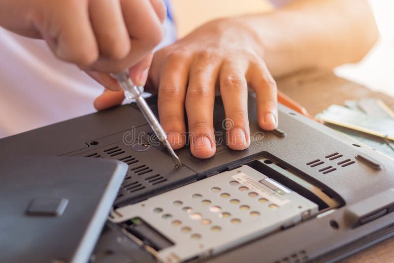 Repairman restores the laptop,Installing the hard drive hardware stock photo Repairman restores the laptop,Installing the hard drive hardware stock photo