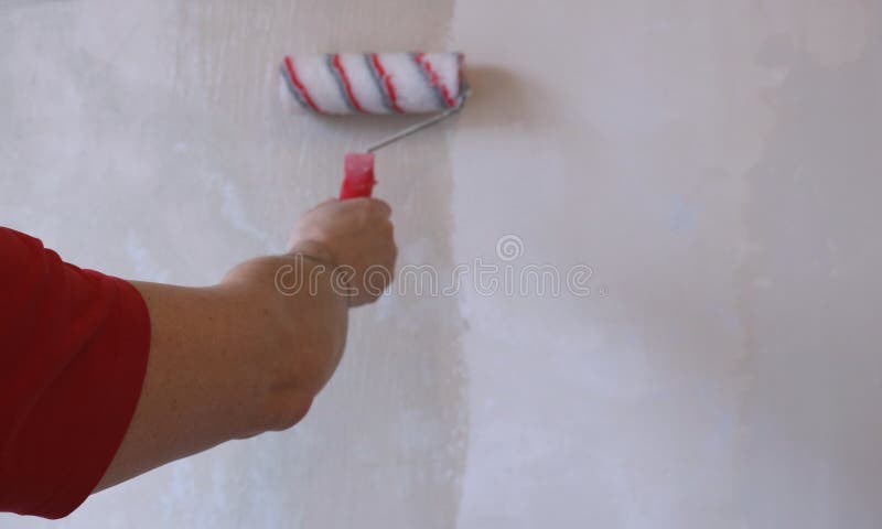 A Man Applies Wallpaper Glue With Brush For Wallpapering Repair Of