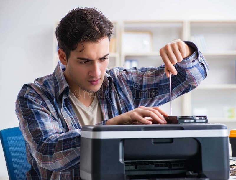 The hardware repairman repairing broken printer fax machine. The hardware repairman repairing broken printer fax machine