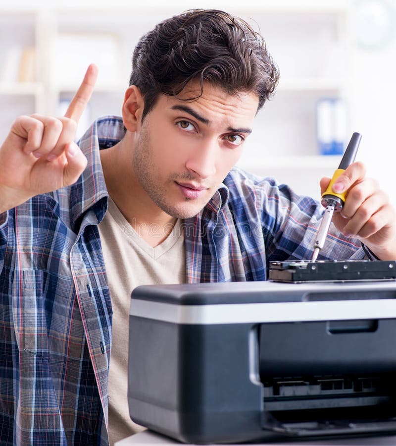 The hardware repairman repairing broken printer fax machine. The hardware repairman repairing broken printer fax machine