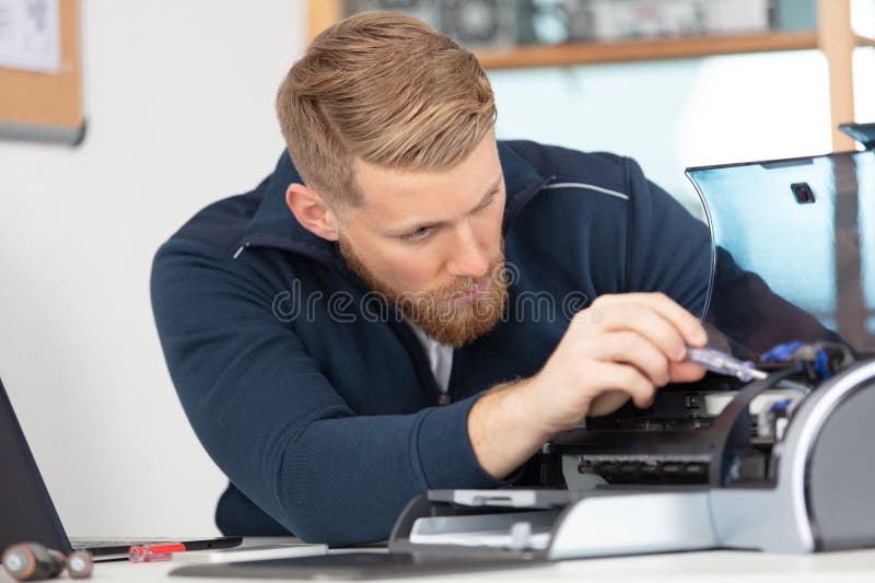 hardware repairman repairing broken printer fax machine malfunction. hardware repairman repairing broken printer fax machine malfunction