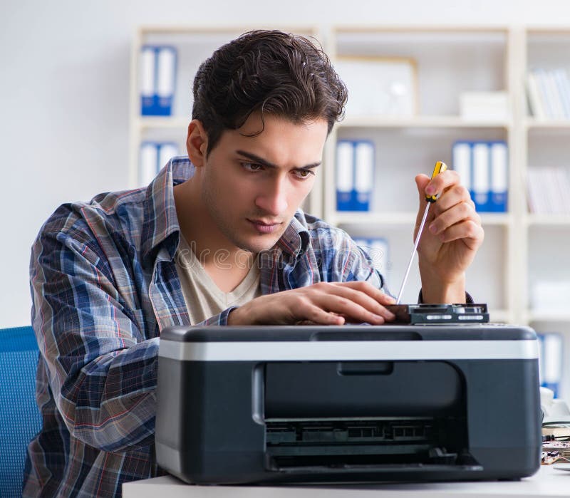 The hardware repairman repairing broken printer fax machine. The hardware repairman repairing broken printer fax machine