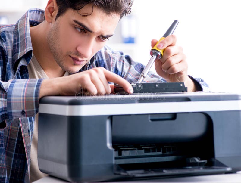 The hardware repairman repairing broken printer fax machine. The hardware repairman repairing broken printer fax machine