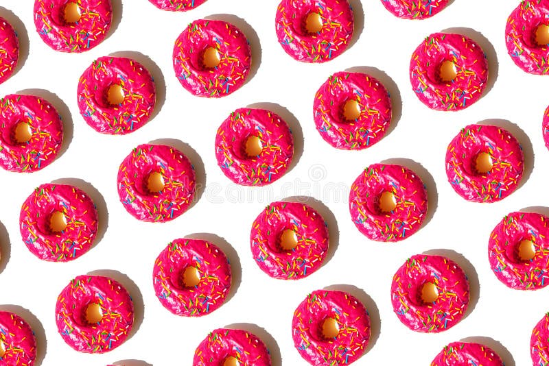 Repeating seamless pattern of identical pink donuts
