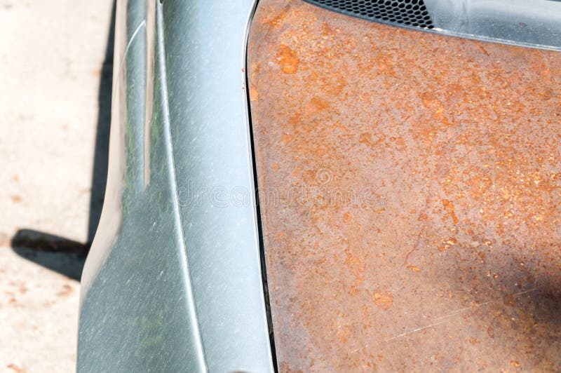 Replaced damaged car hood with cheap rusted one without paint after car crash accident stock image Replaced damaged car hood with cheap rusted one without paint after car crash accident stock image
