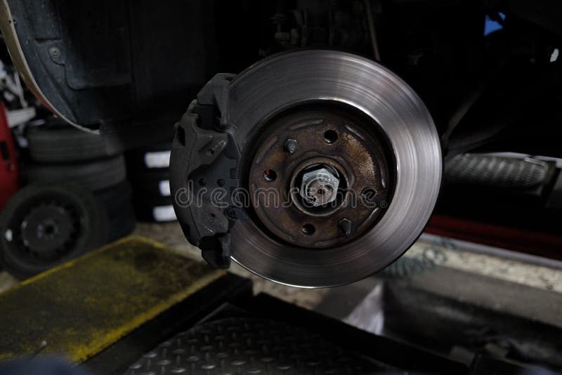 Replacement of disc brakes stock image. Image of mechanic 104940767