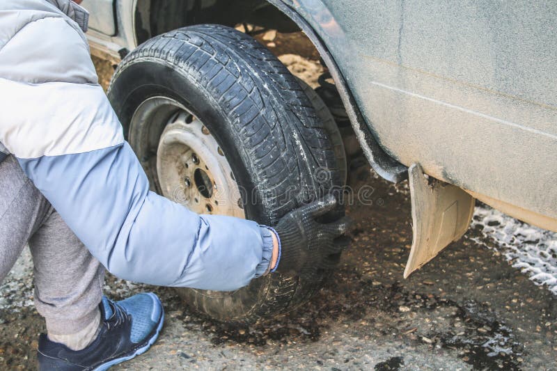Replacing Lug Nuts By Hand While Changing Tires On A Vehicle. Stock