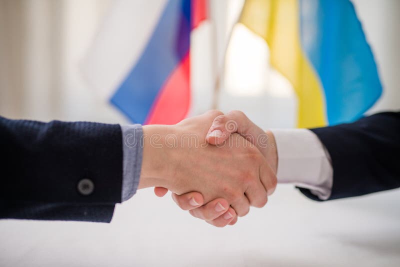 The representatives of Ukraine and Russia shaking hands, Ukraine peace agreement concept.