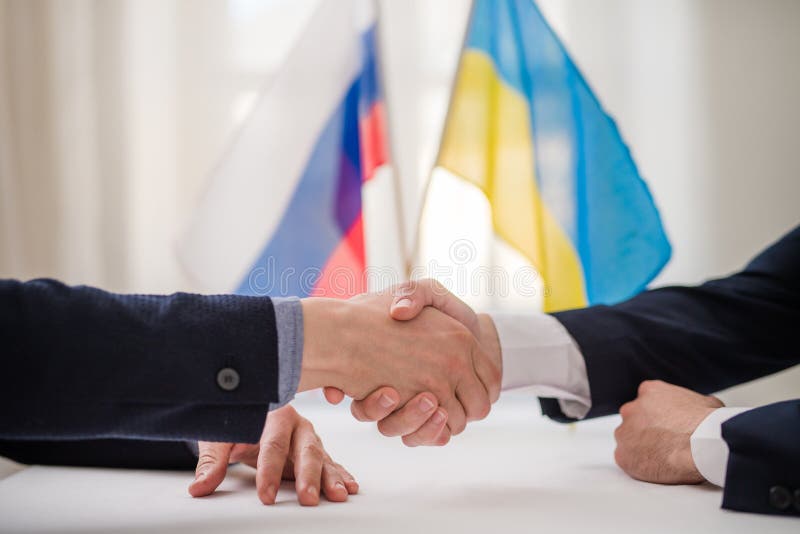 The representatives of Ukraine and Russia shaking hands, Ukraine peace agreement concept.