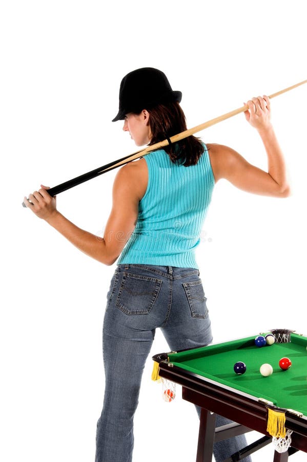 young woman in jeans and a hat with a pool cue and her back to the table. young woman in jeans and a hat with a pool cue and her back to the table