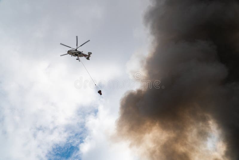 Rescue helicopter drops water extinguishes the fire royalty free stock photos